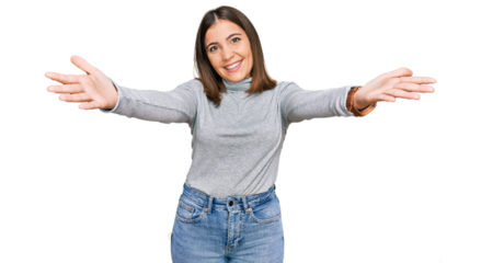 Young beautiful woman wearing casual turtleneck sweater smiling cheerful offering hands giving assistance and acceptance.