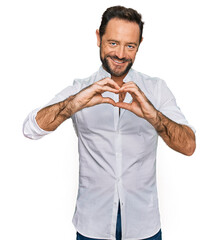 Middle age man wearing casual clothes smiling in love doing heart symbol shape with hands. romantic concept.