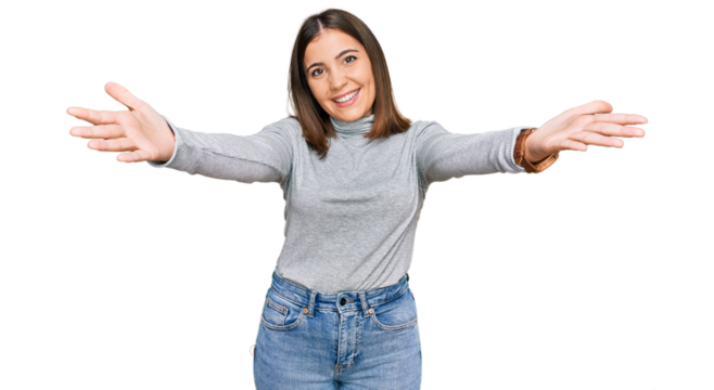 Young beautiful woman wearing casual turtleneck sweater smiling cheerful offering hands giving assistance and acceptance.