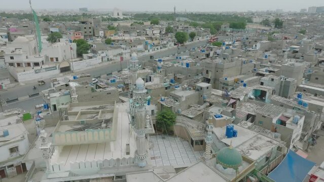 Aerial drone footage of white stone buildings and traffic in Lines Area, Karachi