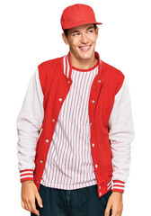 Handsome caucasian man wearing baseball uniform looking away to side with smile on face, natural expression. laughing confident.