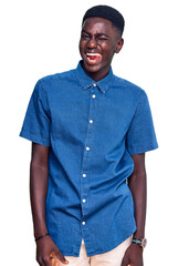Fototapeta premium Young african american man wearing casual clothes winking looking at the camera with sexy expression, cheerful and happy face.