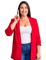 Young beautiful brunette woman wearing elegant clothes showing and pointing up with finger number one while smiling confident and happy.