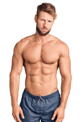 Fototapeta premium Young caucasian man standing shirtless skeptic and nervous, frowning upset because of problem. negative person.