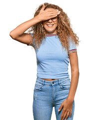 Fototapeta premium Beautiful caucasian teenager girl wearing casual clothes and glasses smiling and laughing with hand on face covering eyes for surprise. blind concept.