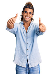 Young hispanic man wearing summer style approving doing positive gesture with hand, thumbs up smiling and happy for success. winner gesture.