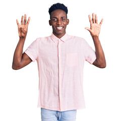 Young african american man wearing casual clothes showing and pointing up with fingers number nine...