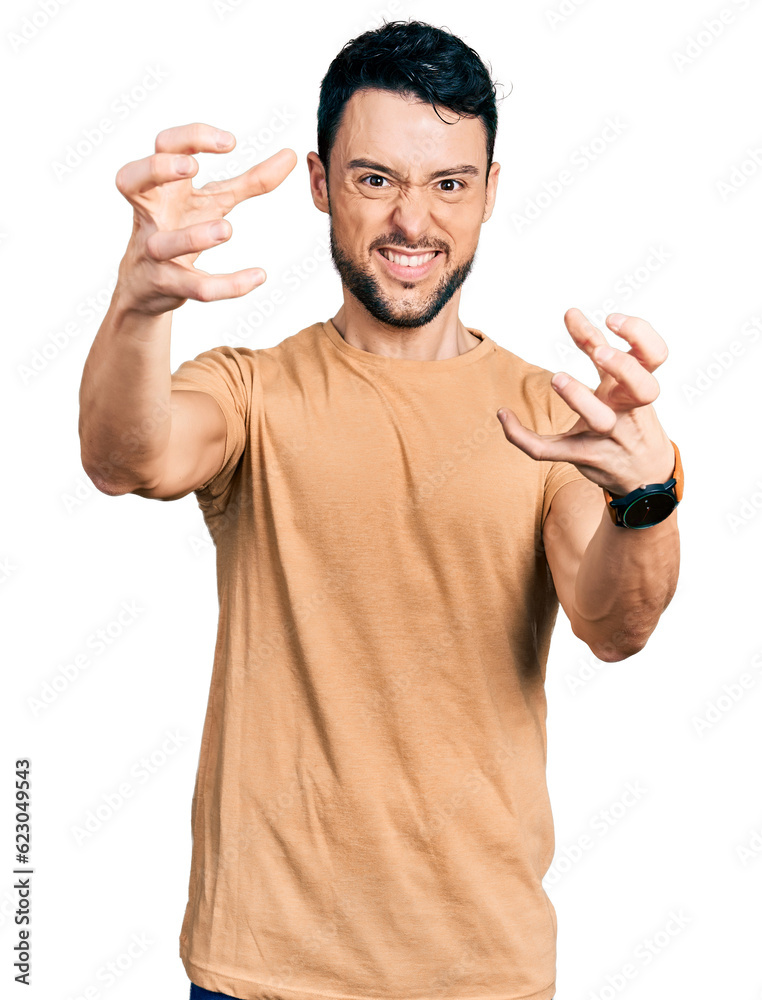 Poster Hispanic man with beard wearing casual t shirt shouting frustrated with rage, hands trying to strangle, yelling mad