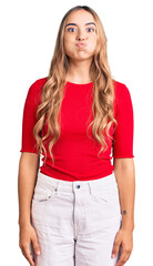 Fototapeta premium Young beautiful blonde woman wearing casual clothes puffing cheeks with funny face. mouth inflated with air, crazy expression.