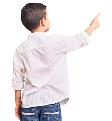 Cute blond kid wearing elegant shirt posing backwards pointing ahead with finger hand © Krakenimages.com