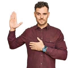 Young hispanic man wearing casual clothes swearing with hand on chest and open palm, making a...