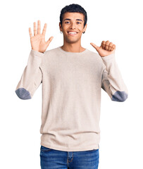 Young african amercian man wearing casual clothes showing and pointing up with fingers number six while smiling confident and happy.