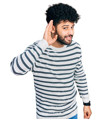 Young arab man with beard wearing casual striped sweater smiling with hand over ear listening an hearing to rumor or gossip. deafness concept.