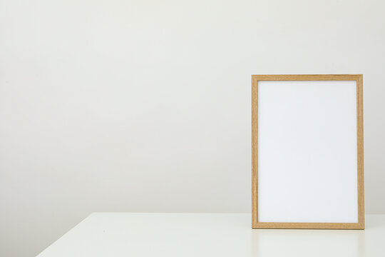 Wooden photo frame on the table on a white background