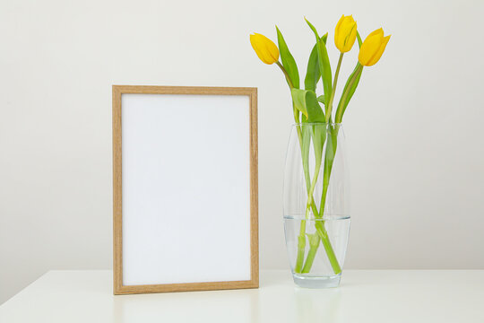 Photo frame with yellow flowers on a light background