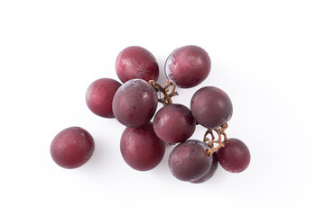 Delicious bunch of grapes fruit spilled over white table background.
