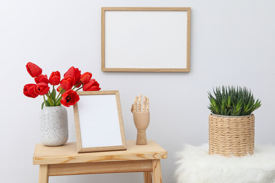 Wall and table frame with vase of flowers and figurine