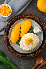 Delicious Thai mango sticky rice with cut fresh mango fruit in a plate.