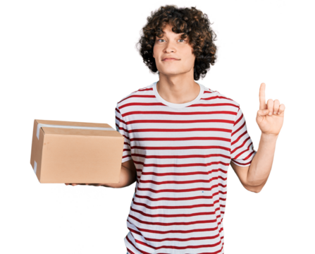 Caucasian teenager holding delivery package smiling with an idea or question pointing finger with happy face, number one
