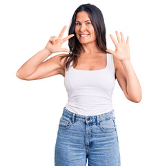 Young beautiful brunette woman wearing casual sleeveless t-shirt showing and pointing up with fingers number eight while smiling confident and happy.