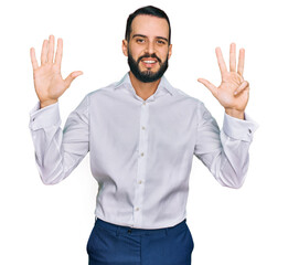 Young man with beard wearing business shirt showing and pointing up with fingers number nine while smiling confident and happy.