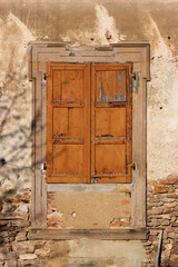 Baroque window with closed shutters on the dilapidated Augustinian monastery building in Pfaffen-Schwabenheim, Germany