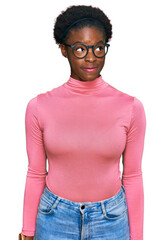 Young african american girl wearing casual clothes and glasses smiling looking to the side and staring away thinking.