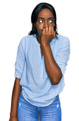 Young african american woman wearing casual clothes looking stressed and nervous with hands on mouth biting nails. anxiety problem.