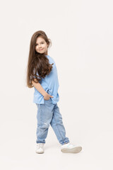 Full-length portrait of positive child girl sin a blue T-shirt and blue jeans isolated on white background.