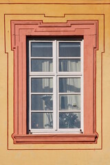 Baroque window with dirty broken panes on the Augustinian monastery facade in Pfaffen-Schwabenheim, Germany