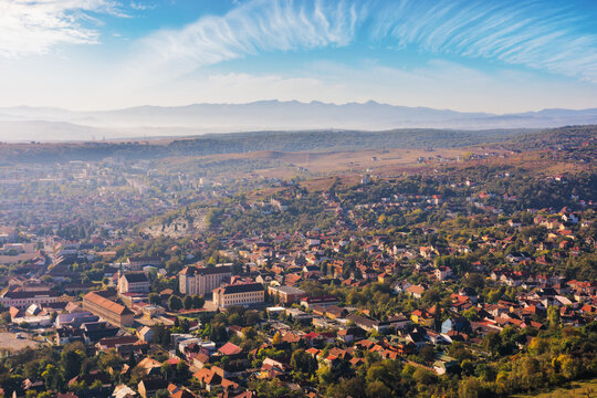 view from above of a small town deva on a hazy morning. beautiful urban scenery in carpathian mountains of romania