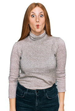 Young irish woman wearing casual clothes making fish face with lips, crazy and comical gesture. funny expression.