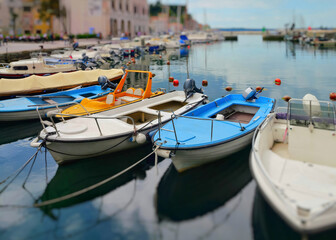 Fototapeta na wymiar Multi-colored boats on the pier in the port of Piran, Slovenia.