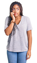 Fototapeta premium Young african american woman with braids wearing casual clothes looking stressed and nervous with hands on mouth biting nails. anxiety problem.