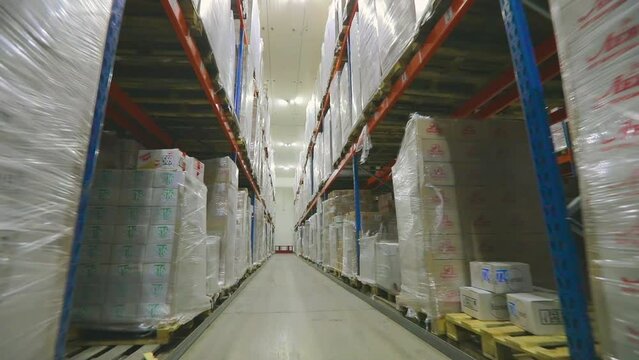 Large modern warehouse with goods without people. The camera moves through the factory warehouse. Modern warehouse, industrial interior