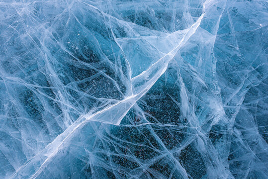 Amazing ice crack texture background, Close-up texture surface cracks of the natural ice in frozen water at Baikal lake, Russia.