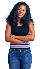 Beautiful african american woman wearing casual clothes happy face smiling with crossed arms looking at the camera. positive person.