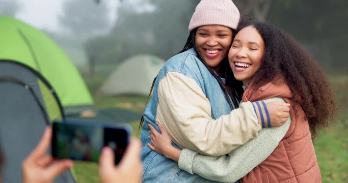 Women friends, photographer and phone at camp with hug, care and memory with smile for post on social media. People, profile picture and happy for camping, adventure and holiday in forrest together