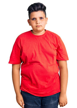 Little boy kid wearing casual clothes with serious expression on face. simple and natural looking at the camera.