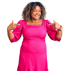 Young african american plus size woman wearing casual clothes looking confident with smile on face, pointing oneself with fingers proud and happy.