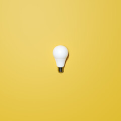 White Lightbulb With Yellow Background