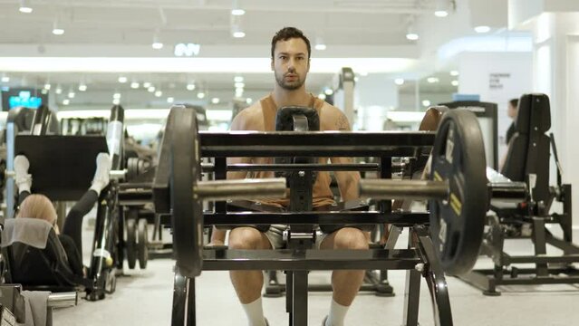 Man training Lower Chest Muscles in Seated Leverage Decline Chest Press Machine at Dym - slow motin front view