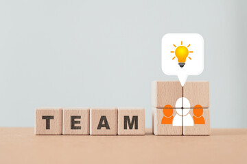 TEAM text on wooden cube blocks and speech bubble with lightbulb inside, relationship of collaboration   group of community ,corporate, teamwork for brainstorming together, business concepts