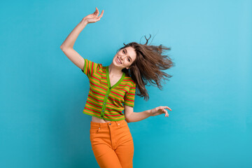 Photo of positive gorgeous girl with curly hairstyle wear striped shirt fluttering hair on wind...
