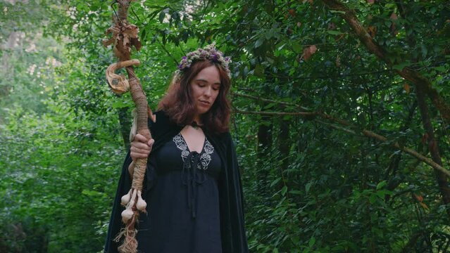 young druid girl walking in a forest pan medium shot