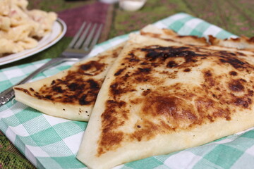 Plate of Pasta Carbonara With Italian Flat Bread on Rustic Table