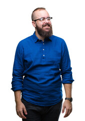 Fototapeta premium Young caucasian hipster man wearing glasses over isolated background looking away to side with smile on face, natural expression. Laughing confident.