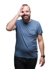 Obraz premium Young caucasian hipster man over isolated background doing ok gesture with hand smiling, eye looking through fingers with happy face.