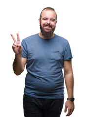 Fototapeta premium Young caucasian hipster man over isolated background smiling with happy face winking at the camera doing victory sign. Number two.