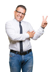Middle age bussines arab man wearing glasses over isolated background smiling with happy face winking at the camera doing victory sign. Number two.